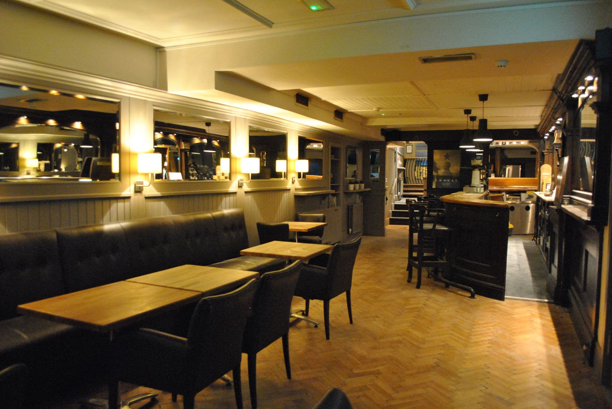 Goggins of Monkstown interior - elegant pub with teal walls, banquette seating, and warm lighting